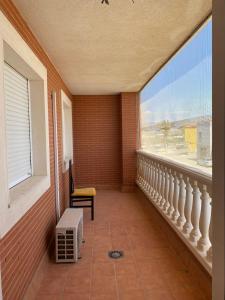 a balcony of a house with a large window at Apartamento en el parque natural in El Cabo de Gata