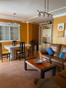 a living room with a couch and a table at Apartamento en el parque natural in El Cabo de Gata