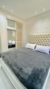 a bedroom with a large bed and a large mirror at Big appartment near soccer stadium in Tangier in Tangier