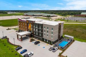 an aerial view of a hotel with a parking lot at Hawthorn Extended Stay by Wyndham Sulphur Lake Charles in Sulphur