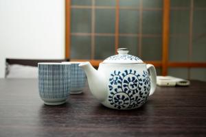 a blue and white tea pot and a cup on a table at Kamiyama Mansion - Vacation STAY 14621 in Osaka