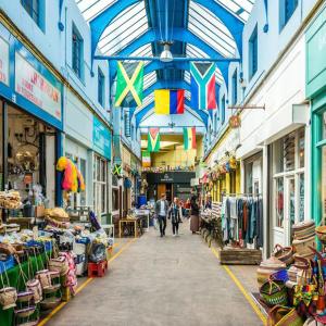 a market with people walking down a street with shops at 2 bed luxury flat in Lambeth in London