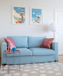 a blue couch in a living room with a table at Oja residents in Pärnu