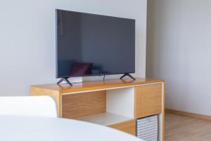 a tv sitting on top of a wooden stand at Oja residents in Pärnu