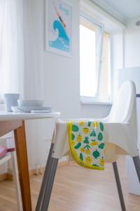 a white chair with a pillow on it next to a table at Oja residents in Pärnu