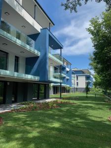 an exterior view of a building with a lawn at Fűzliget2- Green Lake in Balatonfůzfő