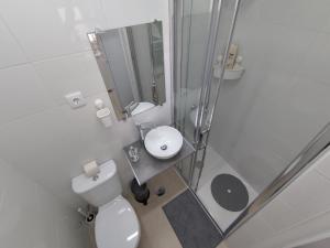 a white bathroom with a toilet and a sink at Room Dream Beato in Lisbon
