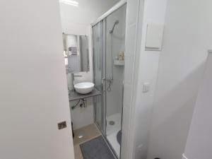 a white bathroom with a sink and a shower at Room Dream Beato in Lisbon