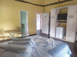 Cama ou camas em um quarto em Pousada Terraço Penedo