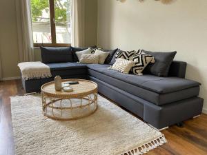 a living room with a blue couch and a table at Bamboo City in Magdeburg