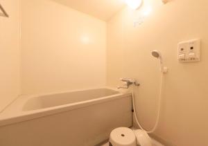a bathroom with a bath tub and a toilet at Katsuura Hilltop Hotel & Residence - Vacation STAY 73528v in Katsuura