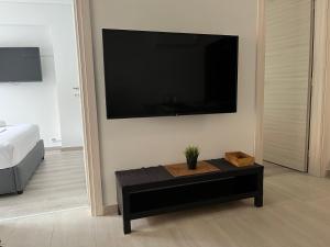 a living room with a large flat screen tv on the wall at Vamelon in Athens