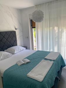 a bedroom with a bed with two towels on it at Tijara Apartment in Rijeka