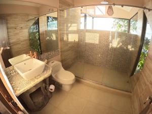 a bathroom with a toilet and a sink and a shower at Eco Lodge SOL- SUE in La Mesa