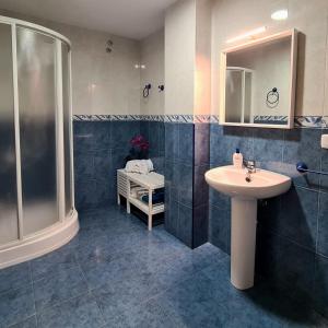 a bathroom with a sink and a shower at La viajera Espadan in Algimia de Almonacid