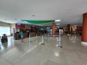 a woman is standing in a lobby with a bar at Prive Riviera - Apartamentos JN in Caldas Novas +52 photos