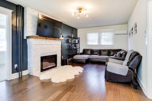 a living room with a couch and a fireplace at Folcroft Vacation Rental about 10 Mi to Philadelphia! 