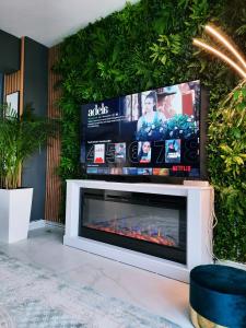 a fireplace with a tv on top of it at Penthouse View Aeroport Iasi in Iaşi