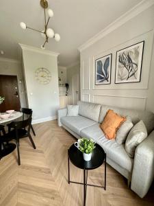 a living room with a couch and a table at Mariensztat Old Town Apartment in Warsaw +14 photos