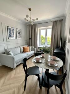 a living room with a couch and a table at Mariensztat Old Town Apartment in Warsaw