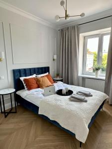 a bedroom with a bed with a laptop on it at Mariensztat Old Town Apartment in Warsaw