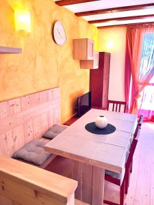 a dining room table with a white bowl on top of it at La Casa Bianca - ski, hike & bike in Passo del Tonale