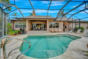 a swimming pool in the backyard of a house at Tranquil Haven in Marco Island