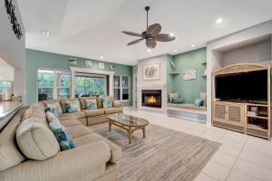 a living room with a couch and a tv and a fireplace at Tranquil Haven in Marco Island