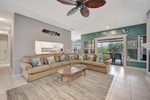 a living room with a couch and a table at Tranquil Haven in Marco Island