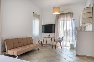 a living room with a couch and a table at Villa Rodanthi Sivota in Syvota