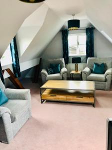 a living room with couches and a coffee table at The Annexe at Walnut Tree Cottage in Hope under Dinmore