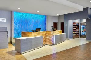 a lobby with a counter with a blue wall at Fairfield Inn and Suites by Marriott Nashville Downtown/The Gulch in Nashville