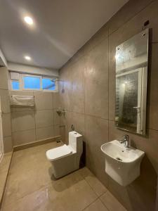 a bathroom with a toilet and a sink at Castra villas - Pool Villa in Parunthumpara in Vandiperiyār +27 photos