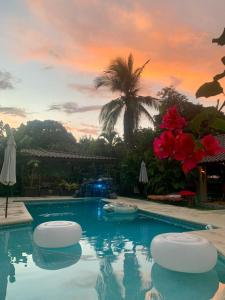 a swimming pool with two stools in the middle at Casa Swell Coronado, Adults-Only Boutique Hotel, Pool & Beach in Playa Coronado
