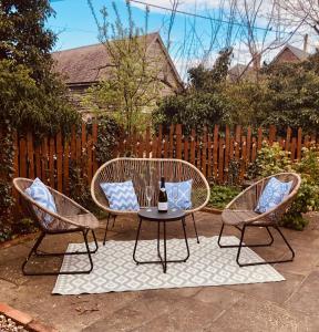 a patio with two chairs and a table and a fence at The Annexe at Walnut Tree Cottage in Hope under Dinmore