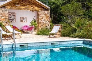 a patio with chairs and a swimming pool at Mai's Cottage in Stari Grad