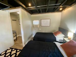 two beds in a small room with a mirror at Cabin 9 at Horse Creek Resort in Rapid City