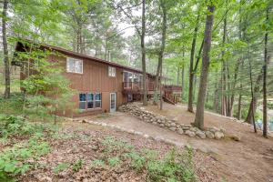 a house in the middle of the woods at Traverse City Retreat with Deck and Lake Access in Traverse City