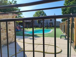 a fence with a pool and a playground at GITE PROVENCE LUBERON -PACA- Acces PMR-ANCV in Revest-des-Brousses