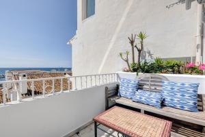 a balcony with a bench and plants on a building at Puerto Banus Harbour View Apartment in Marbella