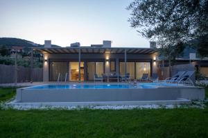 a house with a swimming pool in the yard at Averto Villas with private pool in Nydri