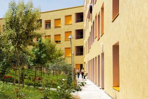 a group of people walking down a sidewalk next to a building at New and Comfy Studio with Mountain View at 'Mangalem21 Complex' in Tirana