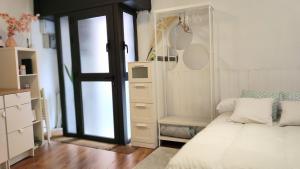 a bedroom with a bed and a closet and a door at Park Güell estudio in Barcelona