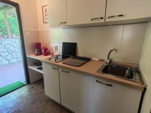 a kitchen with a sink and a counter top at Apartment Lada in Dramalj +15 photos