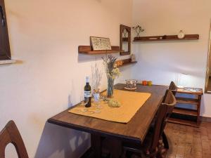 a table with a bottle of wine and glasses on it at Apartment Lada in Dramalj