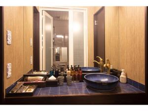 a bathroom counter with two sinks and a mirror at Oita Onsen Business Resort Sourin - Vacation STAY 73386v in Oita