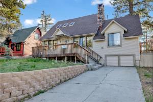 a white house with a brick retaining wall at Pine Nest Relaxing Walk to Marina Cozy Chalet in Big Bear Lake