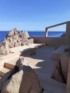 een loopbrug met rotsen en de oceaan op de achtergrond bij Villetta Rocchi - Costa Paradiso in Costa Paradiso