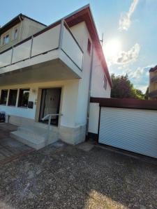 a white house with two garage doors at Haus 140 qm für Monteure in Bad Salzschlirf