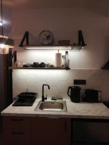 a kitchen with a sink and a counter top at Simά Apartments in Heraklio Town